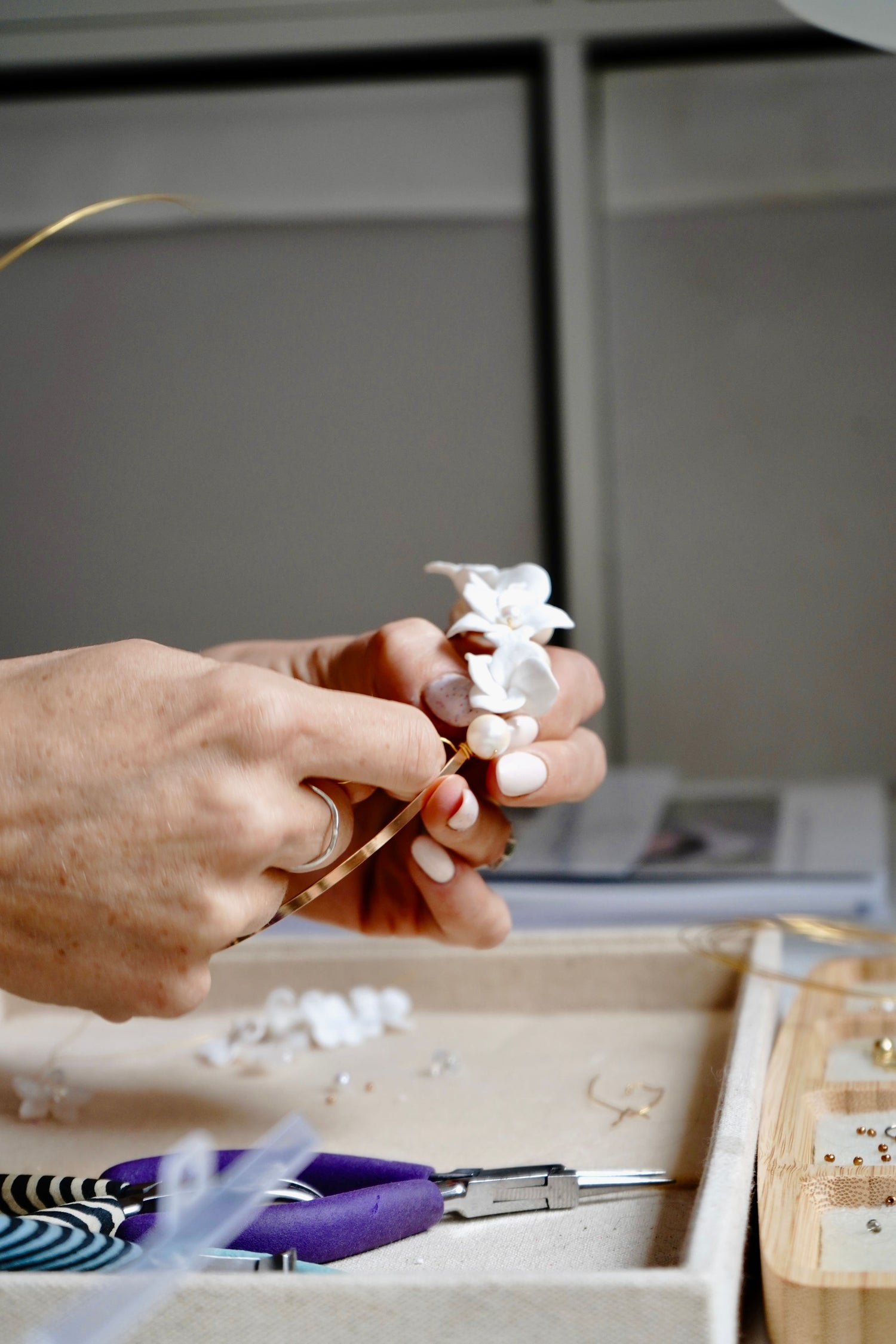 Person working with pliars to make bridal jewellery in a studio