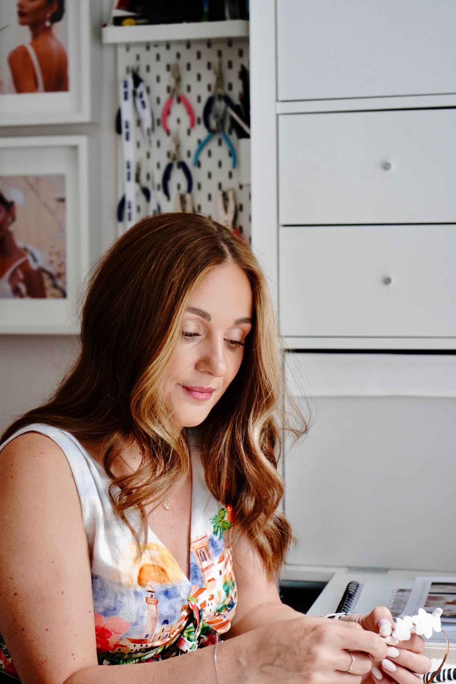 Woman sitting at a desk making bridal jeweller by hand